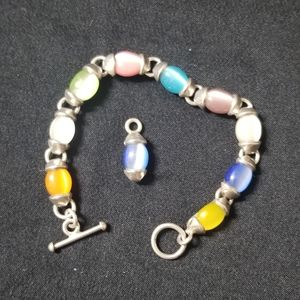 Sterling silver bracelet and pendant with gems.